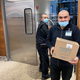 Man near grocery store freezer door holding box of Ripple
